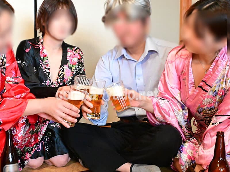 色とりどりの浴衣を来たコンパニオンたちと乾杯する男性