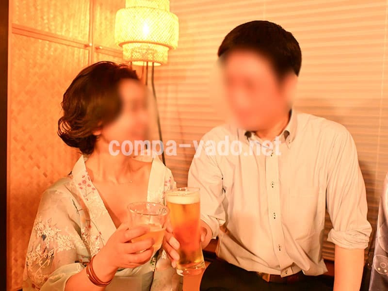 ビールを持って乾杯する男女